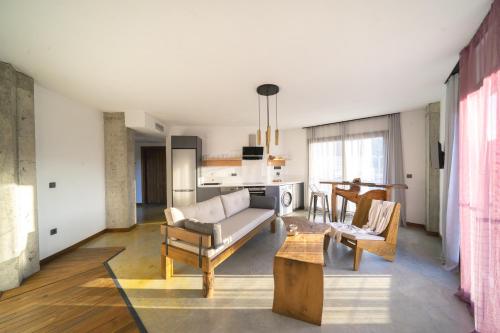 a living room with a couch and a table at Kikonia Art & Suites in Akyaka