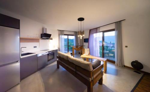 a living room with a couch and a kitchen at Kikonia Art & Suites in Akyaka