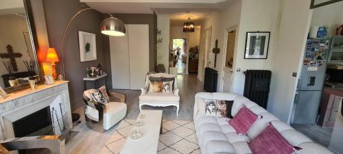 un salon avec deux canapés blancs et une cheminée dans l'établissement Le Cocon de Chris - Petit bijou au calme avec vue Notre-Dame de la Garde, à Marseille