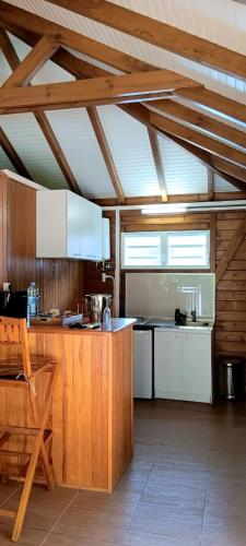 a kitchen with wooden cabinets and a counter top at Nature Paradise Pool & Spa - Exceptional Secluded Luxury Location in Le Diamant
