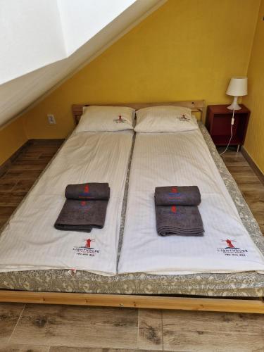 a bed with two pillows on it in a room at LIGHTHOUSE - Adults Only - 12Plus in Krynica Morska
