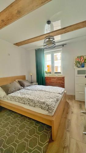 a bedroom with a large bed in a room at Stara Piekarnia Tolkmicko in Tolkmicko
