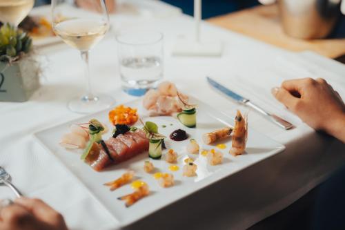 a white plate of food on a table at Parc Hotel Du Lac in Levico Terme