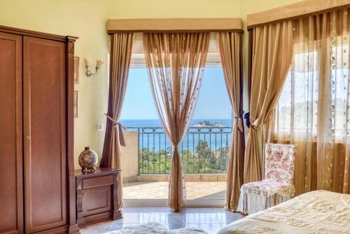 a bedroom with a large window with a view of the ocean at The view villa in Petrovac na Moru