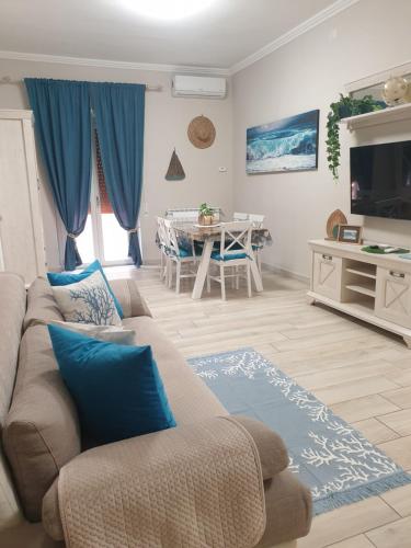 a living room with a couch and a table at Luxury Beach House in Torvaianica
