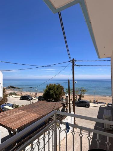 a view of the beach from the balcony of a house at Stegna Sea & Sun in Archangelos