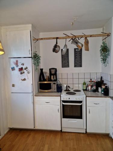 a kitchen with white appliances and a white refrigerator at Disponentgata Malmo Apartment in Malmö