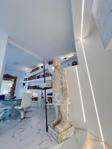 a statue of a man holding an umbrella in a room at ESPECTACULAR Hogar en la playa MARBELLA in Marbella