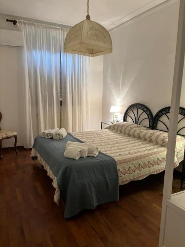 a bedroom with two beds with towels on them at Villa del Monte di Cocco in Massarosa