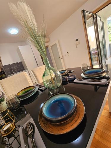 a kitchen with blue plates and a vase on a counter at Sweet suite in Makarska