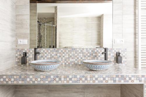 two sinks on a counter in a bathroom at Karlovy Charme Inn by Rentez in Karlovy Vary