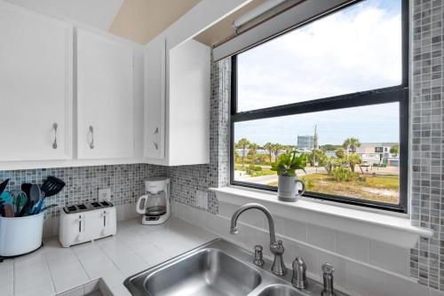 a kitchen with a sink and a window at Beach Side- Harbor View in Destin