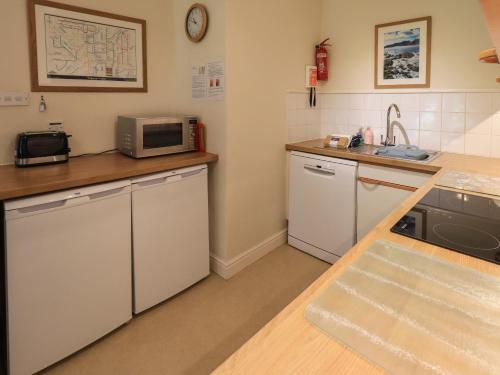 a kitchen with a sink and a microwave at Puddleduck in Ambleside