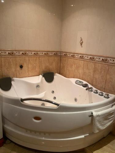 a bath tub sitting in a bathroom with at Duplex T3 Bien Situé in Annaba