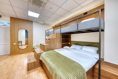 a bedroom with a bunk bed and a mirror at Tropica Inn Hotel in Yerevan