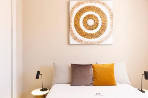 a bedroom with a bed and a picture on the wall at Apartamentos Martalia Áticos Deluxe in Ronda