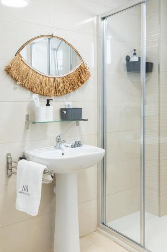 a bathroom with a sink and a shower at Apartamentos Martalia Áticos Deluxe in Ronda