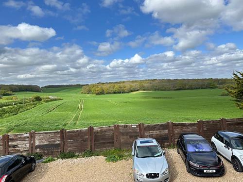 three cars parked next to a fence in front of a field at Bean Farm house Semi Rural Area Security Parking in Stonewood