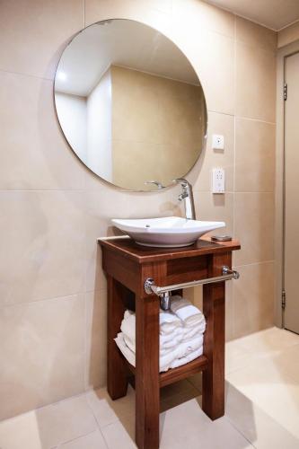 a bathroom with a sink and a mirror at The Royal Yacht in Saint Helier Jersey