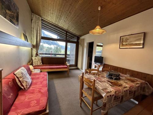 a living room with a couch and a table at Appartement Megève, 2 pièces, 5 personnes - FR-1-597-27 in Megève