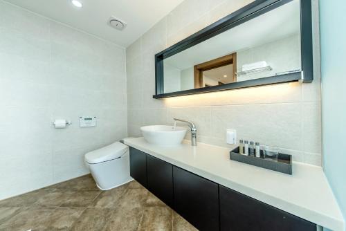 a bathroom with a sink and a mirror at Arts Spa&Poolvilla in Jeju