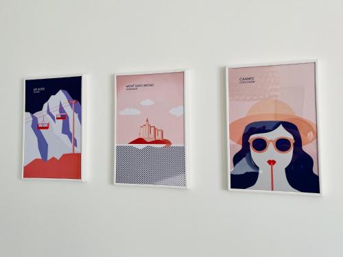 three posters on a wall with a woman in a hat and sunglasses at 2 pièces lumineux aux portes de Paris in Clamart