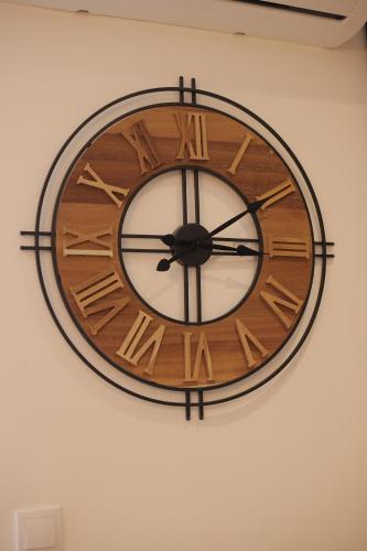 a wooden clock hanging on a wall at Apartman Zivic in Vrnjci