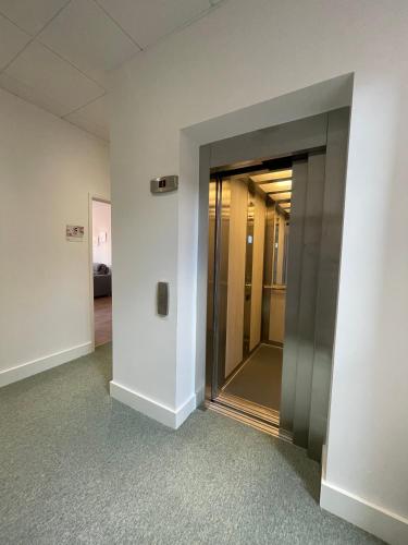 an empty hallway with an elevator in a building at Superb 2BD apartment in China Town in Manchester