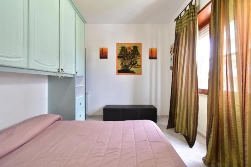 a bedroom with a pink bed and a window at Casa Etnica ID 26215 in Latina