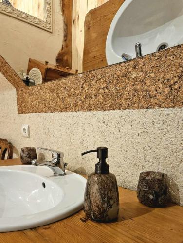 a bathroom sink with a soap dispenser on a counter at SielskoAnielsko k. Karpacza in Łomnica