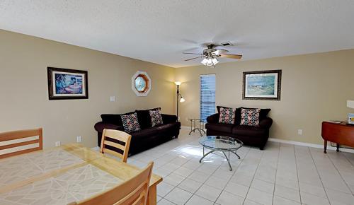 a living room with a couch and a table at The Yellow House in Gulf Breeze