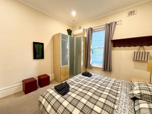 a bedroom with a bed and a window at Subiaco Heritage House "Gem"! in Perth