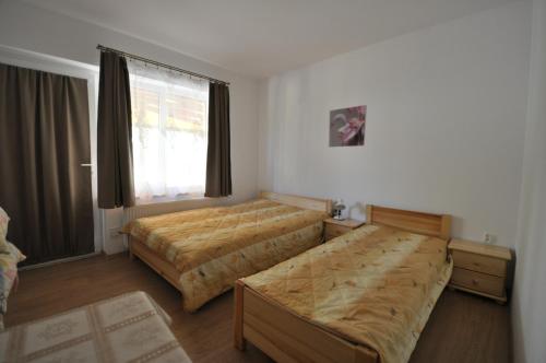 a bedroom with two beds and a window at willa grazyna 2 in Dźwirzyno