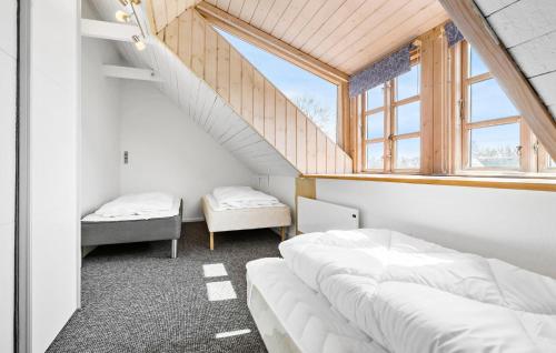 a bedroom with two beds and a window at Nice Home In Grenaa With Wifi in Grenå