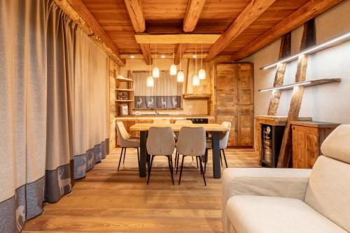 a kitchen and dining room with a table and chairs at Elva Apartments in Elva