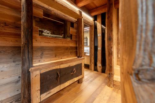 an empty room with wooden walls and a wooden floor at Elva Apartments in Elva
