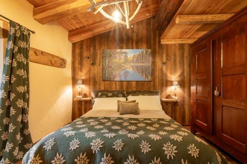 a bedroom with a bed in a room with wooden walls at Elva Apartments in Elva
