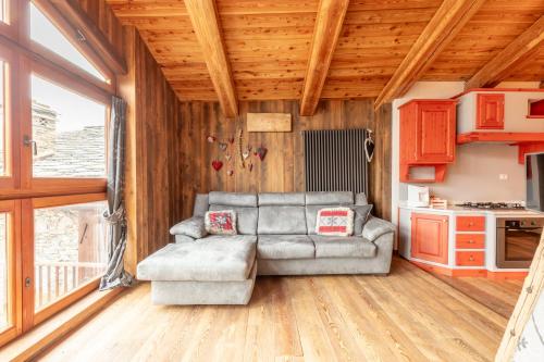 a living room with a couch and a kitchen at Elva Apartments in Elva