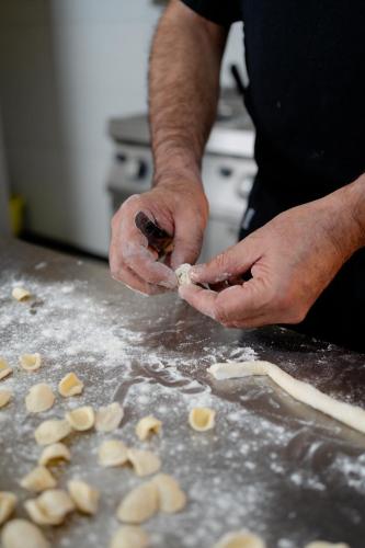 a person is preparing food on a counter at Palazzo Del Duca Hotel & Restaurant in Matera