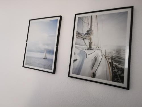 deux photographies encadrées d'un bateau sur un mur dans l'établissement Soleil Levant 2 - En bord de mer - Superbe Appartement Cosy - Accès direct plage - Proche Commerces et Animations, au Barcarès