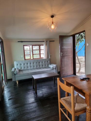 a living room with a couch and a table at 11-on-RobRoy serenity glamping cabins overlooking the Valley of 1000 Hills in Hillcrest