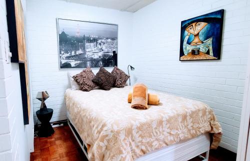 a bedroom with a bed with a teddy bear on it at Quaint & Tranquil Subiaco 1 Bedroom Apartment in Perth