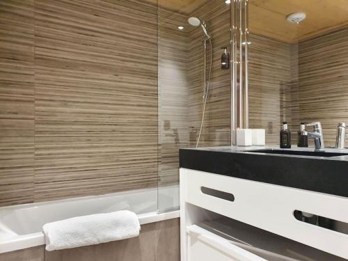 a bathroom with a shower and a sink and a tub at Saskya 5 65m2, 2 bedrooms, next to the ski lift in Samoëns