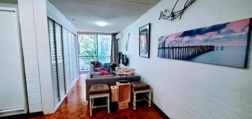 a hallway with a living room with a white wall at Quaint & Tranquil Subiaco 1 Bedroom Apartment in Perth