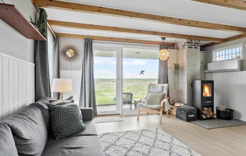 a living room with a couch and a fireplace at 2 Bedroom Beautiful Home In Hurup Thy in Sindrup