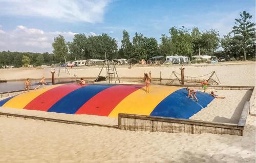 a group of people playing on a colorful circle on the beach at Nice Home In Rheezerveen With Sauna in Rheezerveen