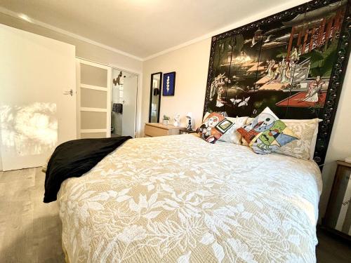 a bedroom with a bed with a large poster on the wall at Serenity And Comfort In Subiaco 1 Bedroom Unit in Perth