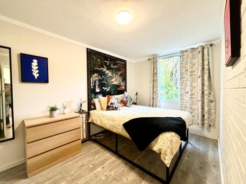 a bedroom with a bed and a dresser and a window at Serenity and Comfort in Subiaco 1 Bedroom Unit in Perth