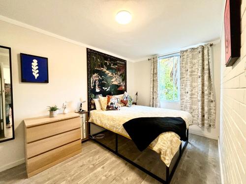 a bedroom with a bed and a dresser and a window at Serenity And Comfort In Subiaco 1 Bedroom Unit in Perth