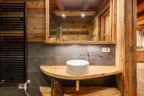 a bathroom with a sink and wooden walls at Elva Apartments in Elva